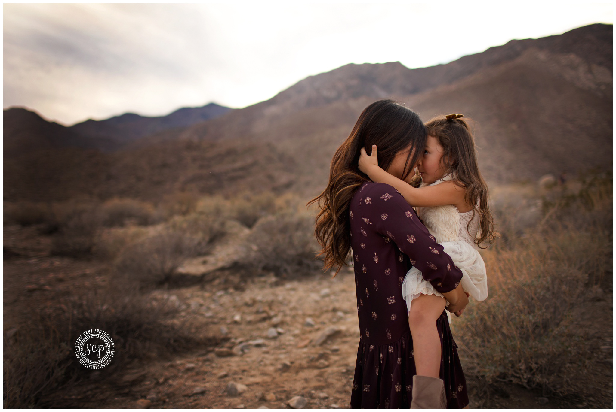 Fun photo between mom and daughter during her family portrait session in Palm Desert